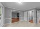 Open dining room with neutral paint, tile floor, and views into the living room and hallway at 2301 Pastille Ln, Raleigh, NC 27612