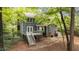 Back exterior view of home featuring a deck, trees, and lawn at 2301 Pastille Ln, Raleigh, NC 27612
