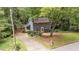 Charming two-story home with long driveway and well-maintained front yard nestled within a wooded landscape at 2301 Pastille Ln, Raleigh, NC 27612