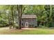 Charming two-story home with red shutters and inviting front yard surrounded by mature trees at 2301 Pastille Ln, Raleigh, NC 27612