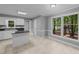 Open kitchen with white cabinets, an island and a view of the backyard at 2301 Pastille Ln, Raleigh, NC 27612