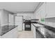 Traditional kitchen featuring white cabinets, black appliances, and granite countertops at 2301 Pastille Ln, Raleigh, NC 27612