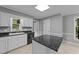 Charming kitchen with white cabinetry, black appliances, granite countertops, and natural lighting at 2301 Pastille Ln, Raleigh, NC 27612