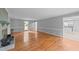 Open-concept room with hardwood floors, gray walls, white trim, and access to the kitchen creates an inviting space at 2301 Pastille Ln, Raleigh, NC 27612