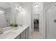Modern bathroom with dual sinks, quartz countertops, sleek fixtures, and a walk-in closet at 251 Olde Pl, Zebulon, NC 27597