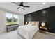 Serene bedroom featuring a large window, accent wall, and comfortable furnishings at 251 Olde Pl, Zebulon, NC 27597