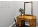 Charming wooden desk with drawers and an elegant mirror against a neutral wall at 251 Olde Pl, Zebulon, NC 27597