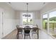 Bright dining area with natural light, stylish chandelier, and sliding door access to the backyard at 251 Olde Pl, Zebulon, NC 27597