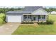Charming single-Gathering home with a well-manicured lawn and attached garage at 251 Olde Pl, Zebulon, NC 27597