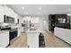 Bright kitchen featuring an island, stainless steel appliances and white cabinetry at 251 Olde Pl, Zebulon, NC 27597