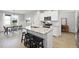 Bright kitchen with granite island, bar seating, stainless appliances, and adjacent dining area at 251 Olde Pl, Zebulon, NC 27597
