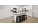 Stylish kitchen featuring a granite island with seating, stainless steel appliances, and white cabinetry at 251 Olde Pl, Zebulon, NC 27597