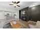 Open-concept living room with fireplace that flows seamlessly into the modern kitchen at 251 Olde Pl, Zebulon, NC 27597