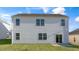 Two-story home's back exterior with lush green lawn, siding, and multiple windows at 281 Hanging Elm Ln, Fuquay Varina, NC 27526