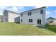 Home's backyard showcasing a green lawn, siding, and sliding glass door entry at 281 Hanging Elm Ln, Fuquay Varina, NC 27526