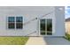 Home featuring a sliding glass door leading to a patio and lush green backyard space at 281 Hanging Elm Ln, Fuquay Varina, NC 27526