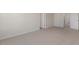 A carpeted bedroom area showing access to a hallway with multiple white doors at 281 Hanging Elm Ln, Fuquay Varina, NC 27526