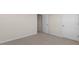 A large bedroom showing a white door accessing a hallway with other rooms at 281 Hanging Elm Ln, Fuquay Varina, NC 27526