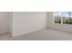 Carpeted bedroom with a window and access to other rooms at 281 Hanging Elm Ln, Fuquay Varina, NC 27526