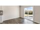 Dining area featuring wood floors and a sliding glass door leading to the outdoor patio at 281 Hanging Elm Ln, Fuquay Varina, NC 27526