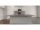 This kitchen has granite countertops on an island with shaker cabinets, and stainless appliances at 281 Hanging Elm Ln, Fuquay Varina, NC 27526