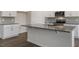Kitchen boasts an island with granite countertops and shaker cabinets, creating a chef's haven at 281 Hanging Elm Ln, Fuquay Varina, NC 27526