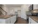 Modern kitchen featuring stainless steel appliances, granite countertops, and shaker-style cabinets at 281 Hanging Elm Ln, Fuquay Varina, NC 27526