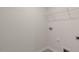 Empty laundry room with hookups ready for washer and dryer and wire shelving above at 281 Hanging Elm Ln, Fuquay Varina, NC 27526