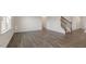 Open-concept living room with hardwood floors and lots of natural light at 281 Hanging Elm Ln, Fuquay Varina, NC 27526