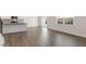 Open-concept living area showcasing wood floors and seamlessly connecting the kitchen to the living room at 281 Hanging Elm Ln, Fuquay Varina, NC 27526