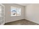 Bright room featuring a large window and wood floors, offering a versatile space at 281 Hanging Elm Ln, Fuquay Varina, NC 27526