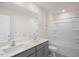Spacious bathroom featuring dual sinks with a shower-tub combo, perfect for a growing Gathering at 292 Perseus St, Angier, NC 27501