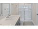 Bright bathroom features a single sink with quartz counters and a shower with glass doors at 292 Perseus St, Angier, NC 27501