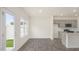Bright kitchen featuring gray cabinets, stainless steel appliances, and a view to the backyard at 292 Perseus St, Angier, NC 27501