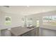 Bright kitchen with island, stainless steel sink, and abundant natural light from multiple windows at 292 Perseus St, Angier, NC 27501