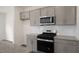 Modern kitchen showcasing stainless steel appliances, gray cabinets, and white subway tile backsplash at 292 Perseus St, Angier, NC 27501