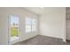 Bright living room with natural light, hard wood floors, a door to the outside and white trim at 292 Perseus St, Angier, NC 27501