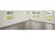 Spacious living room with three large windows and a door to the outside bringing in lots of natural light at 292 Perseus St, Angier, NC 27501
