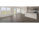 Open-concept living area with modern flooring, natural light, and a view into the kitchen at 292 Perseus St, Angier, NC 27501