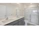 Main bathroom featuring double sinks, quartz counters, a shower, and a toilet at 292 Perseus St, Angier, NC 27501