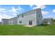 A lush green backyard with a concrete patio and sliding glass doors at 298 Hanging Elm Ln, Fuquay Varina, NC 27526