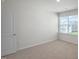 Bedroom featuring neutral carpet and a large window with view at 298 Hanging Elm Ln, Fuquay Varina, NC 27526