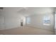 Spacious bedroom with neutral carpeting and bright natural light from two windows at 298 Hanging Elm Ln, Fuquay Varina, NC 27526