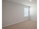 Bedroom featuring neutral carpet and a large window at 298 Hanging Elm Ln, Fuquay Varina, NC 27526