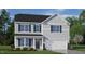 Charming two-story home with light siding, dark shutters, and a well-manicured front lawn at 298 Hanging Elm Ln, Fuquay Varina, NC 27526