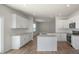 Spacious kitchen featuring white cabinets, an island, and stainless steel appliances at 298 Hanging Elm Ln, Fuquay Varina, NC 27526