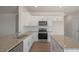 Eat-in kitchen features granite countertops, stainless steel appliances, and white cabinetry at 298 Hanging Elm Ln, Fuquay Varina, NC 27526