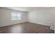 Spacious living room featuring wood-look floors, neutral walls, and lots of natural light at 298 Hanging Elm Ln, Fuquay Varina, NC 27526