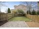 Fenced backyard featuring manicured lawn, paving stones and gravel at 310 Millsfield Drive Dr, Cary, NC 27519