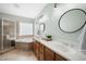 Well-lit bathroom with double vanity, soaking tub, and glass enclosed shower at 310 Millsfield Drive Dr, Cary, NC 27519